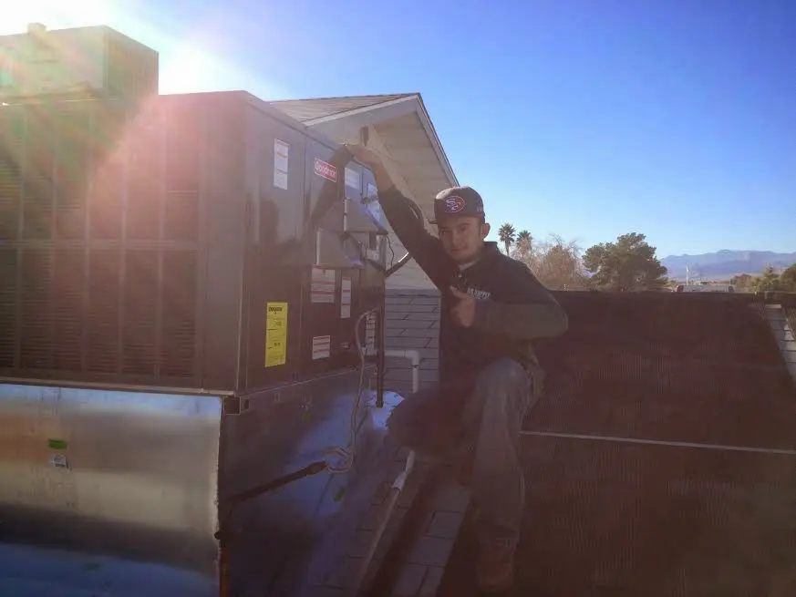 HVAC technician performing Boiler Repair on a rooftop unit in Cockeysville